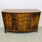 A REPRODUCTION MAHOGANY 4 DRAWER 2 DOOR BOW FRONT SIDEBOARD - W 130CM. D 46CM. H 88CM.