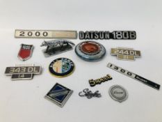 COLLECTION OF VINTAGE CAR BADGES ALONG WITH A RADIATOR MASCOT IN THE FORM OF A FOX