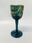 A 13 SIDED LATE GEORGIAN GREEN WINE GLASS ON A FACETED STEM,