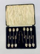 A CASED SET OF TWELVE SILVER APOSTLE COFFEE SPOONS COMPLETE WITH SUGAR NIPS