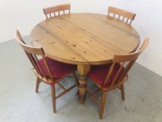 A HONEY PINE CIRCULAR EXTENDING DINING TABLE WITH DROP FLAP SIDES ALONG WITH A SET OF 4 STICK BACK