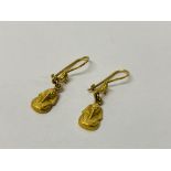 A PAIR OF EGYPTIAN YELLOW METAL EARRINGS