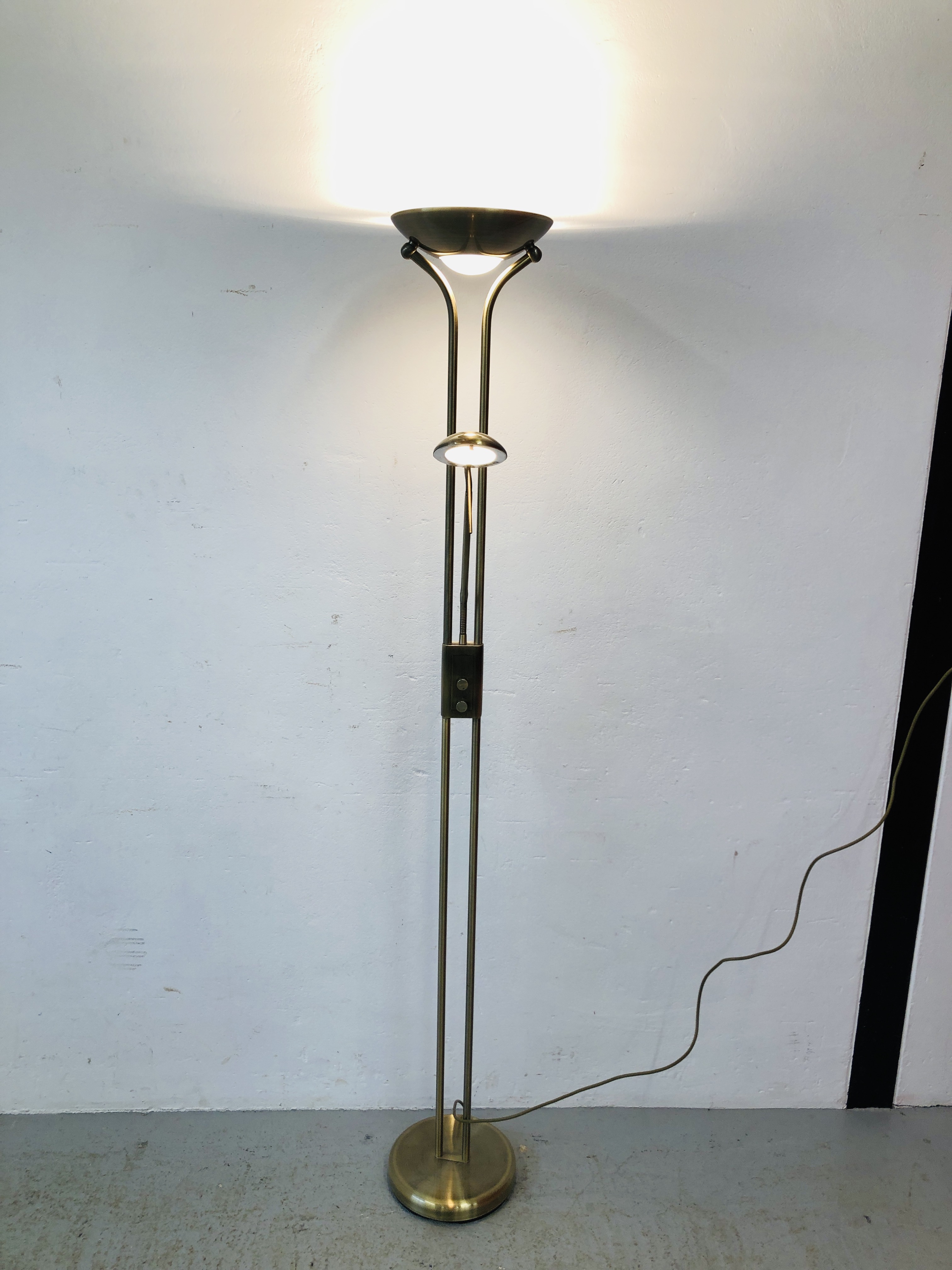 A MODERN BRASS FINISH UPLIGHTER WITH ADJUSTABLE READING LAMP - SOLD AS SEEN