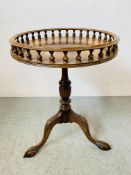 A REPRODUCTION MAHOGANY PEDESTAL OCCASIONAL TABLE WITH CIRCULAR GALLERIED TOP STANDING ON TRIPOD