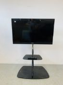 A SONY BRAVIA 40 INCH TELEVISION WITH REMOTE ON AVF CHROME & BLACK GLASS MEDIA STAND - SOLD AS SEEN