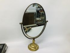 AN ANTIQUE BRASS FRAMED MIRROR ON SWIVEL STAND