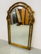 AN ORNATE MODERN, SHAPED WALL MIRROR - W 89CM. H 113CM.