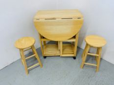 A COMPACT BEECHWOOD DROP FLAP KITCHEN TABLE AND STOOL SET