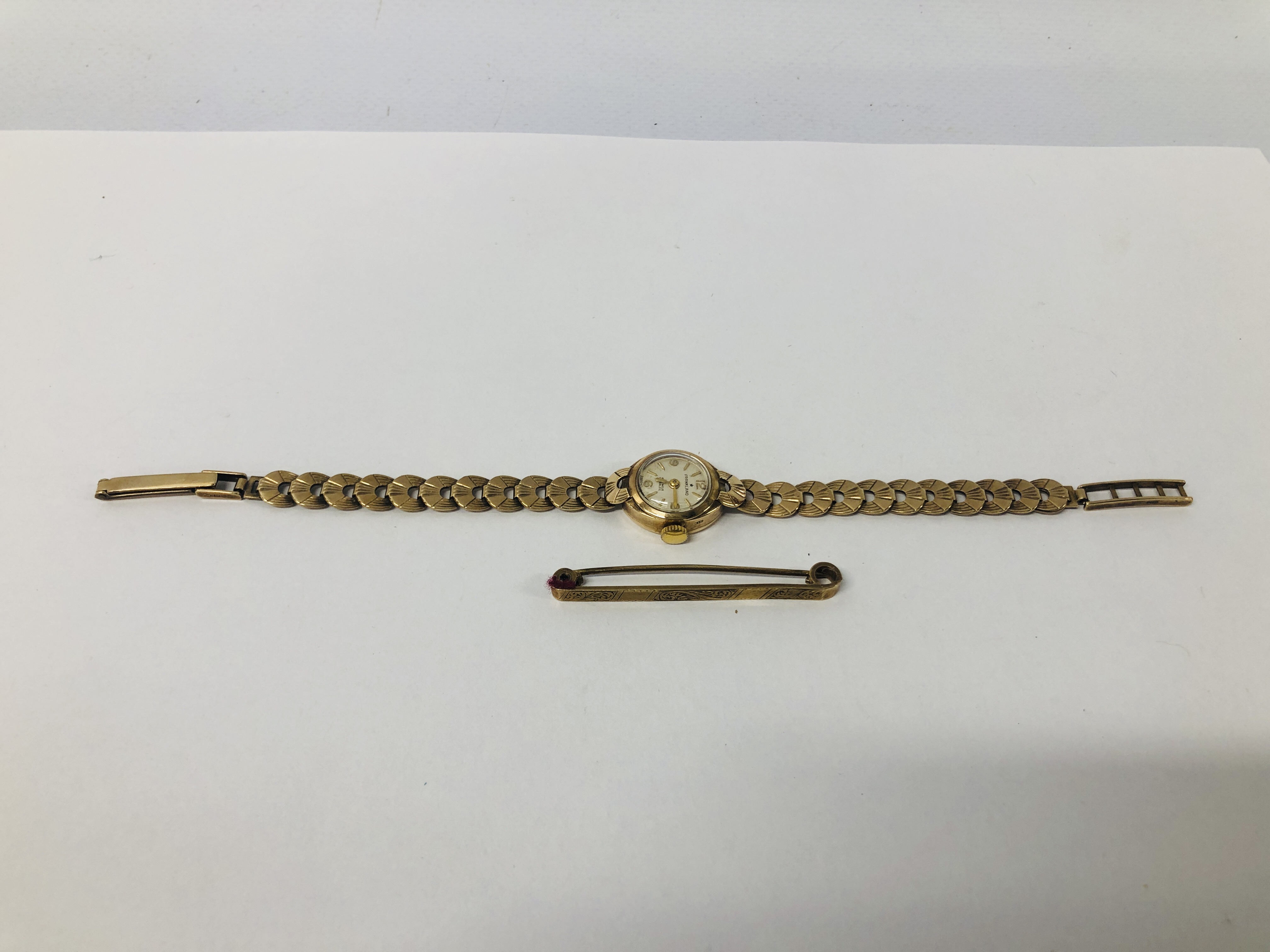 A LADIES 9CT GOLD CASED FRANKLAND WRIST WATCH ON 9CT GOLD BRACELET STRAP ALONG WITH A 9CT GOLD BAR