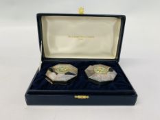 A PAIR OF SILVER AND ENAMEL OCTAGONAL BOXES SURMOUNTED BY A PARROT DESIGN IN FITTED CASE