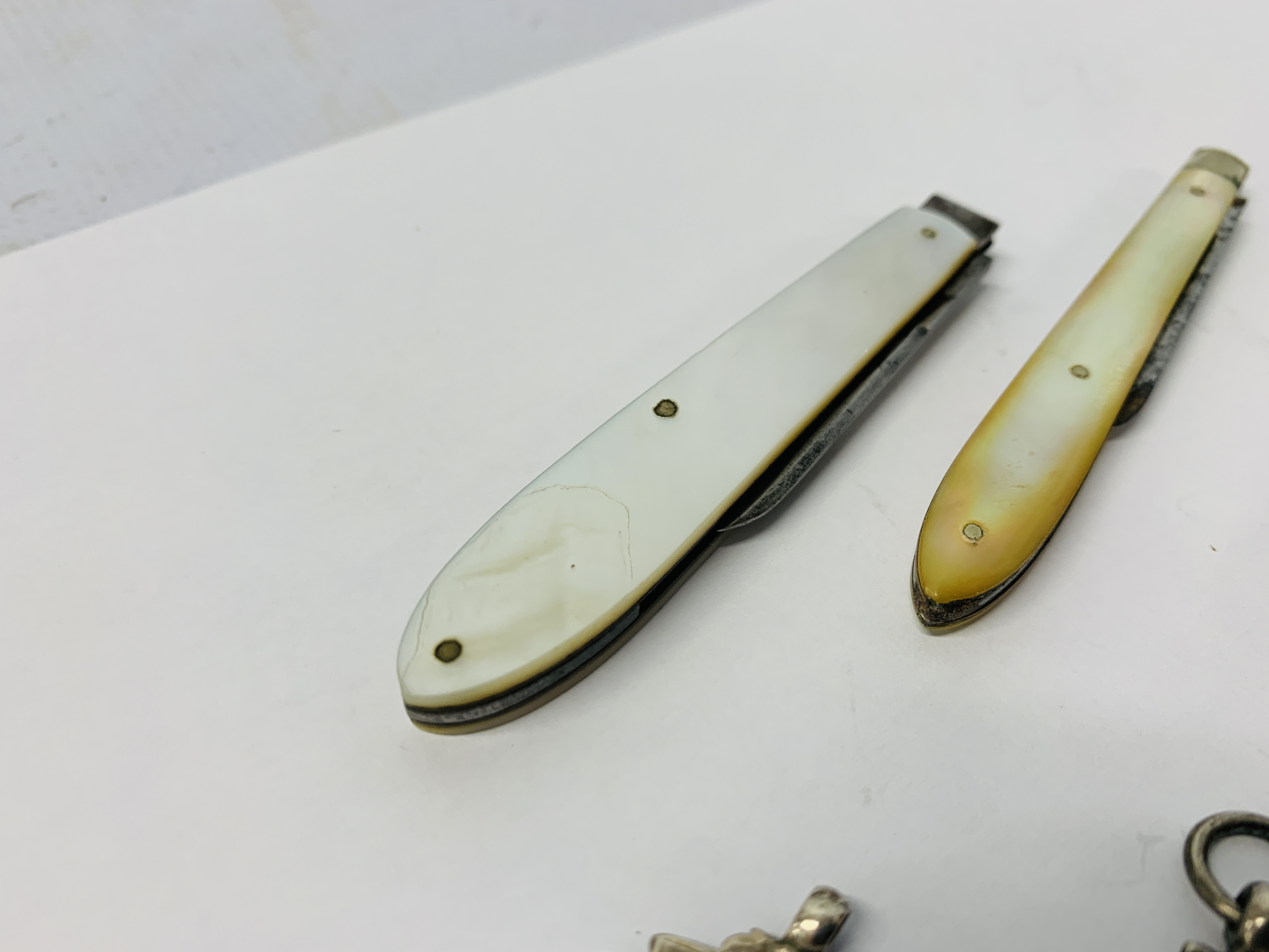 THREE MOTHER OF PEARL HANDLED FRUIT KNIVES AND FOUR SILVER FOOTBALL MEDALS - Image 6 of 6