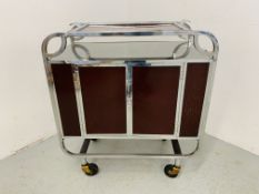 A STYLISH DECO CHROME FRAMED DRINKS TROLLEY WITH HINGED COMPARTMENTAL STORAGE TO EITHER END AND