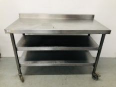 A STAINLESS STEEL COMMERCIAL CATERING THREE TIER PREPARATION TABLE ON CASTORS L 130CM.