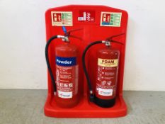 A TWIN FIRE EXTINGUISHER STAND COMPLETE WITH FOAM AND POWDER EXTINGUISHERS (REQUIRES