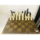 A CHESS SET WITH OVERSIZED ANIMAL FIGURES TALLEST PIECE STANDING AT 19CM,