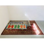 LARGE ORIENTAL PATTERNED RUG ON A RED BACKGROUND 235CM. X 170CM.