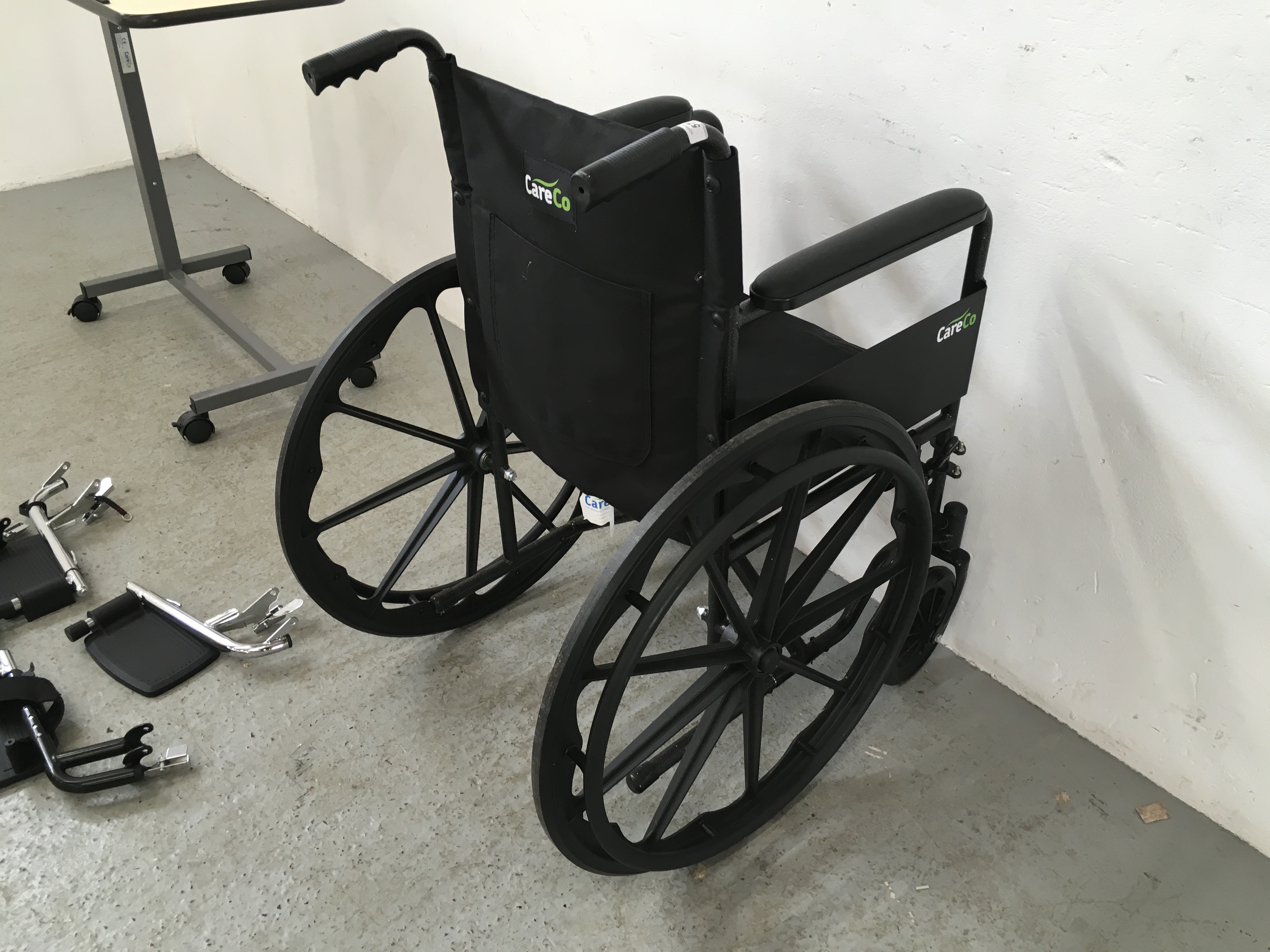 CARE CO WHEEL CHAIR AND FOOT RESTS ALONG WITH A WHEELED BED TRAY - Image 8 of 9