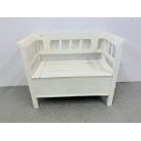 A WHITE PAINTED PINE SETTLE WITH HINGED STORAGE SEAT LENGTH 115CM