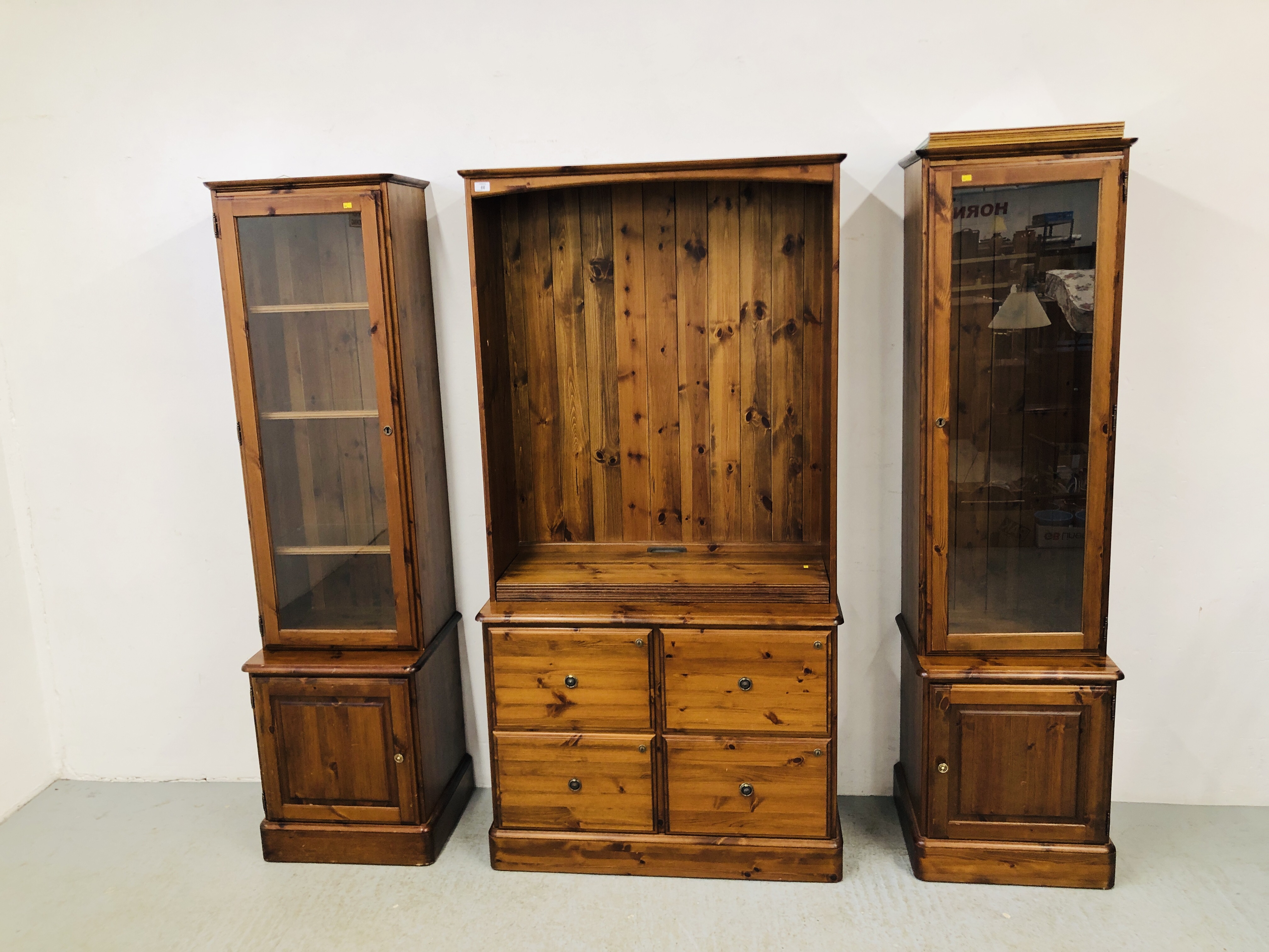 A PAIR OF DUCAL HONEY PINE GLAZED CABINETS WITH CABINET BASES EACH W 51CM. D 44CM. H 89CM.