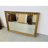 A GILT FRAMED RECTANGULAR WALL MIRROR WITH BEVELLED GLASS - W 102CM. H 71CM.