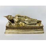 A HEAVY BRASS RECLINING THAI FIGURE ORNAMENT - 51CM LONG. 21CM WIDE. 21CM HIGH.