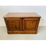 A DUCAL HONEY PINE 2 DOOR CABINET CONCEALING 2 INTERIOR LINED DRAWERS - W 97CM. D 44CM. H 61CM.
