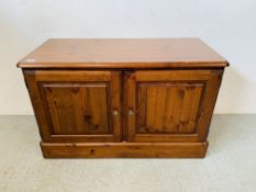 A DUCAL HONEY PINE 2 DOOR CABINET CONCEALING 2 INTERIOR LINED DRAWERS - W 97CM. D 44CM. H 61CM.