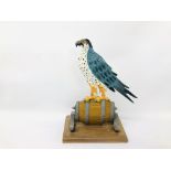 A LARGE CAST METAL PEREGRINE FALCON ON BARREL MOUNTED ON PLINTH IN THE FORM OF LANCONS BEER