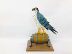 A LARGE CAST METAL PEREGRINE FALCON ON BARREL MOUNTED ON PLINTH IN THE FORM OF LANCONS BEER