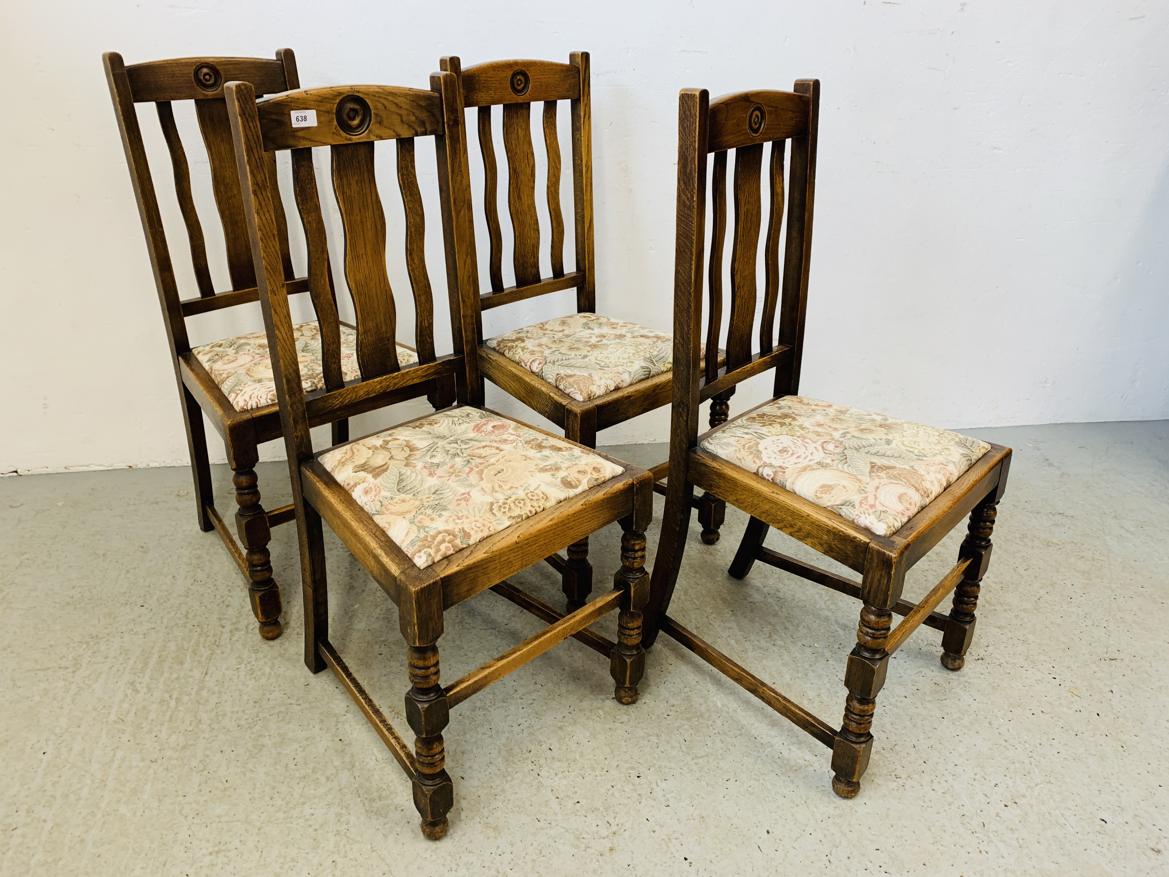 A SET OF FOUR 1940'S OAK DINING CHAIRS WITH SLAT BACK AND BULLSEYE DETAIL