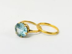 A 22CT GOLD WEDDING BAND AND A SOLITAIRE BLUE STONE SET LADIES RING MARKED 18CT.