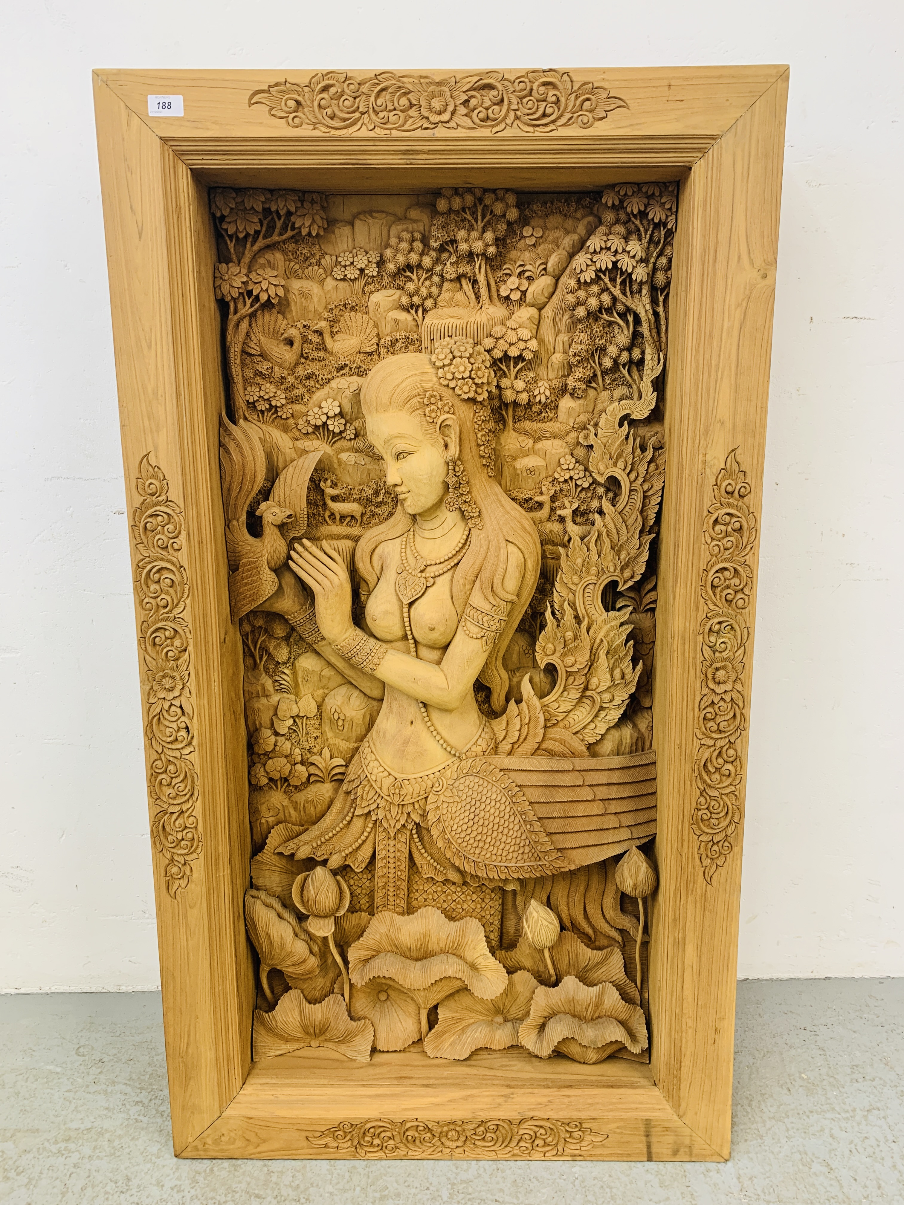 AN IMPRESSIVE ASIAN HAND CARVED TEAK THREE DIMENSIONAL PANEL OF GIRL WITH BIRDS AND FOLIAGE -