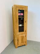 A FULL HEIGHT ACACIA WOOD PART GLAZED CABINET, THE INTERIOR SHELVED WITH CUPBOARD, DOOR TO BASE,