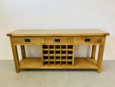 A SOLID LIGHT OAK THREE DRAWER SIDE TABLE WITH FITTED 20 BOTTLE WINE RACK BELOW L 180CM, H 83CM,