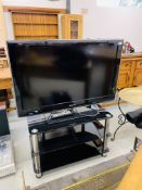 SAMSUNG 40 INCH FLAT SCREEN TV WITH REMOTE ON 3 TIER GLASS TV STAND - SOLD AS SEEN