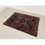 AN EASTERN BLUE / RED PATTERNED RUG 150CM X 110CM.