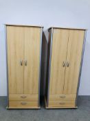 A PAIR OF MODERN BEECHWOOD FINISH DOUBLE WARDROBES WITH DRAWERS TO BASE - EACH W 74CM. D 50CM.
