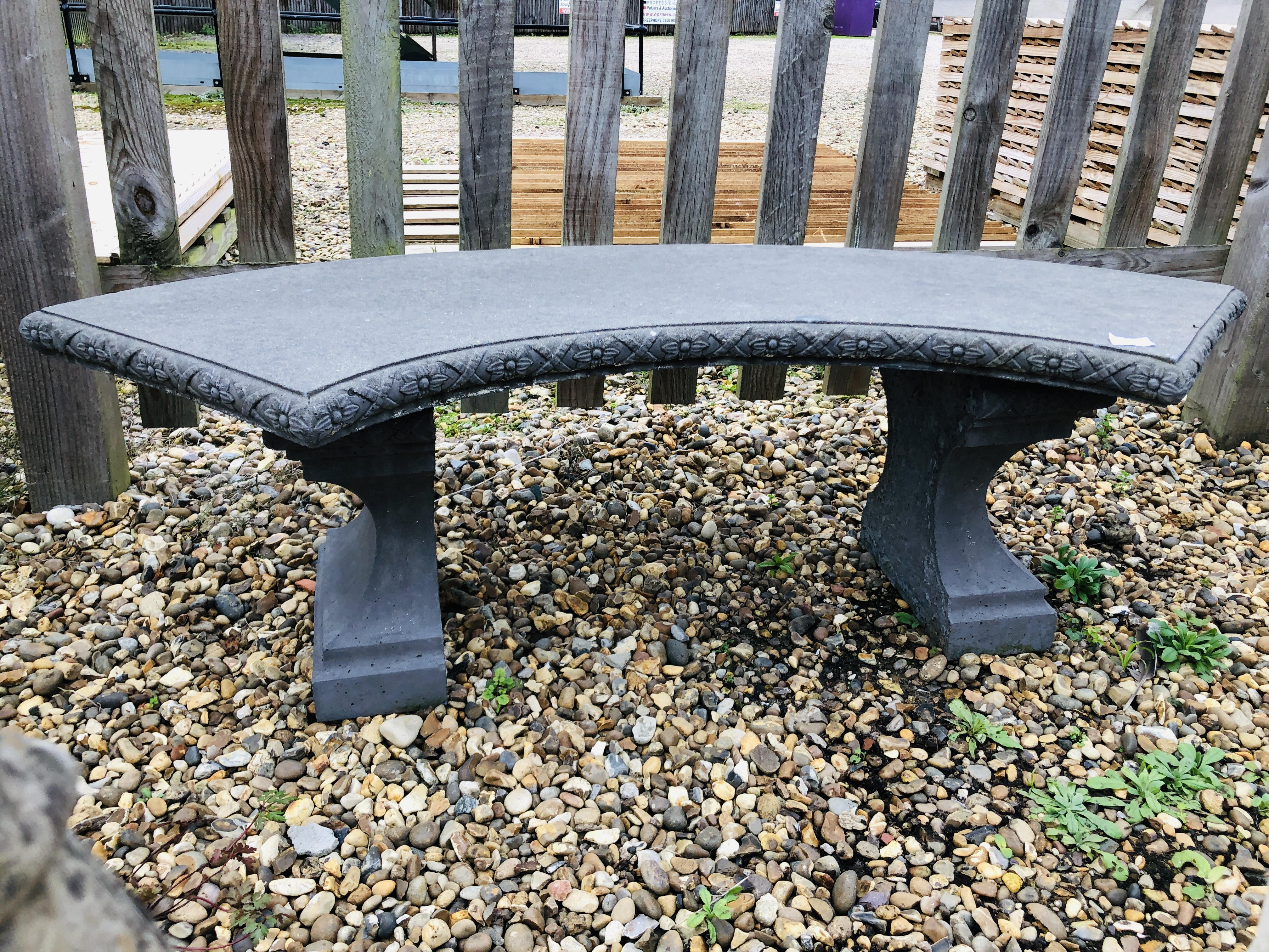 A STONEWORK GARDEN BENCH WITH CARVED SEAT W 130CM