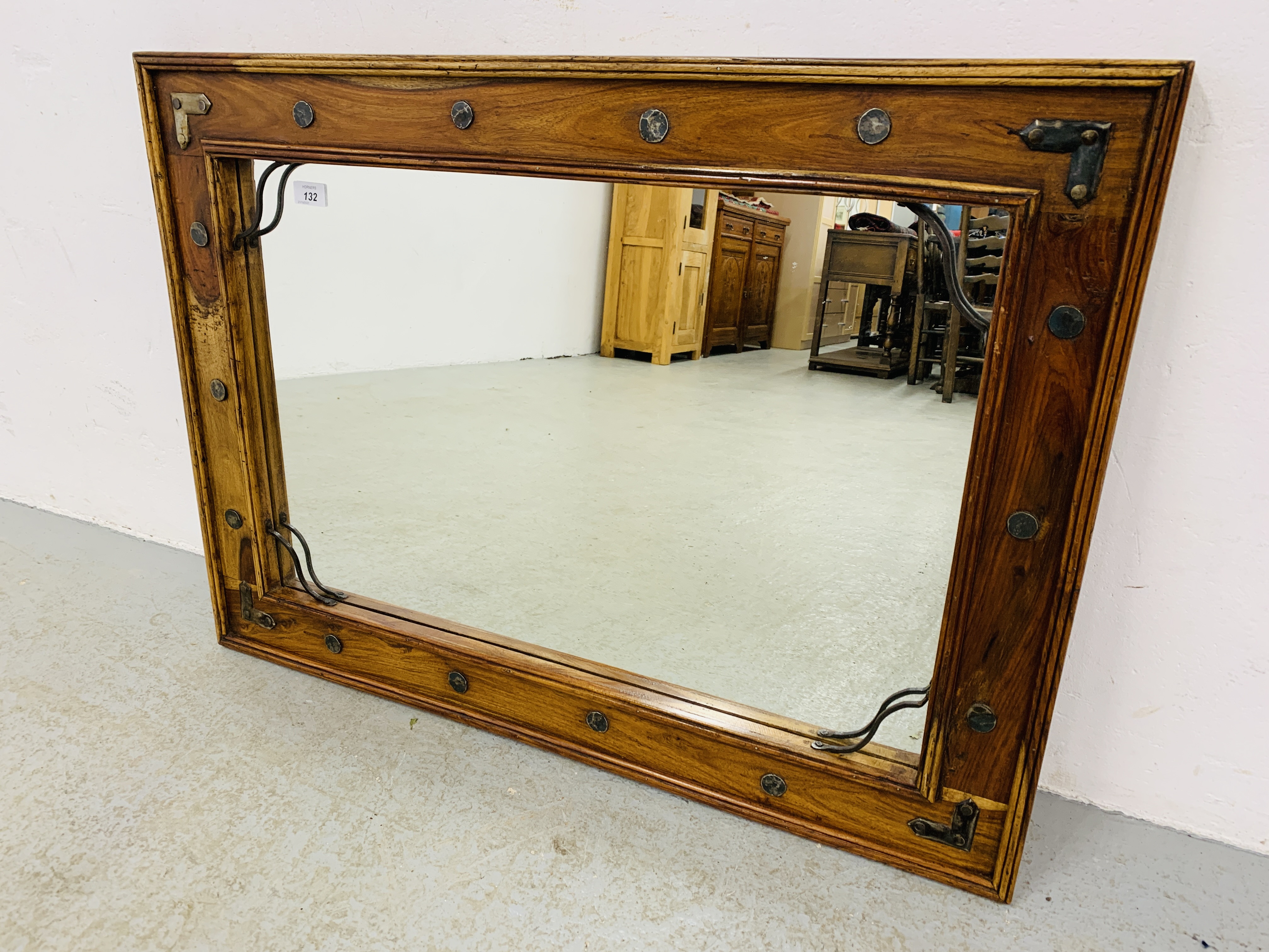 A RUSTIC HARDWOOD RECTANGULAR WALL MIRROR WITH IRON CRAFT DETAIL