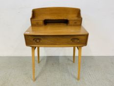 AN ERCOL WINDSOR ELM WRITING DESK - W 69CM. D 45CM. H 95CM.