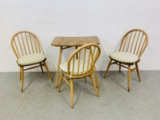 AN ERCOL BLONDE TABLE EXTENSION / DESK WITH THREE ERCOL STICK BACK CHAIRS