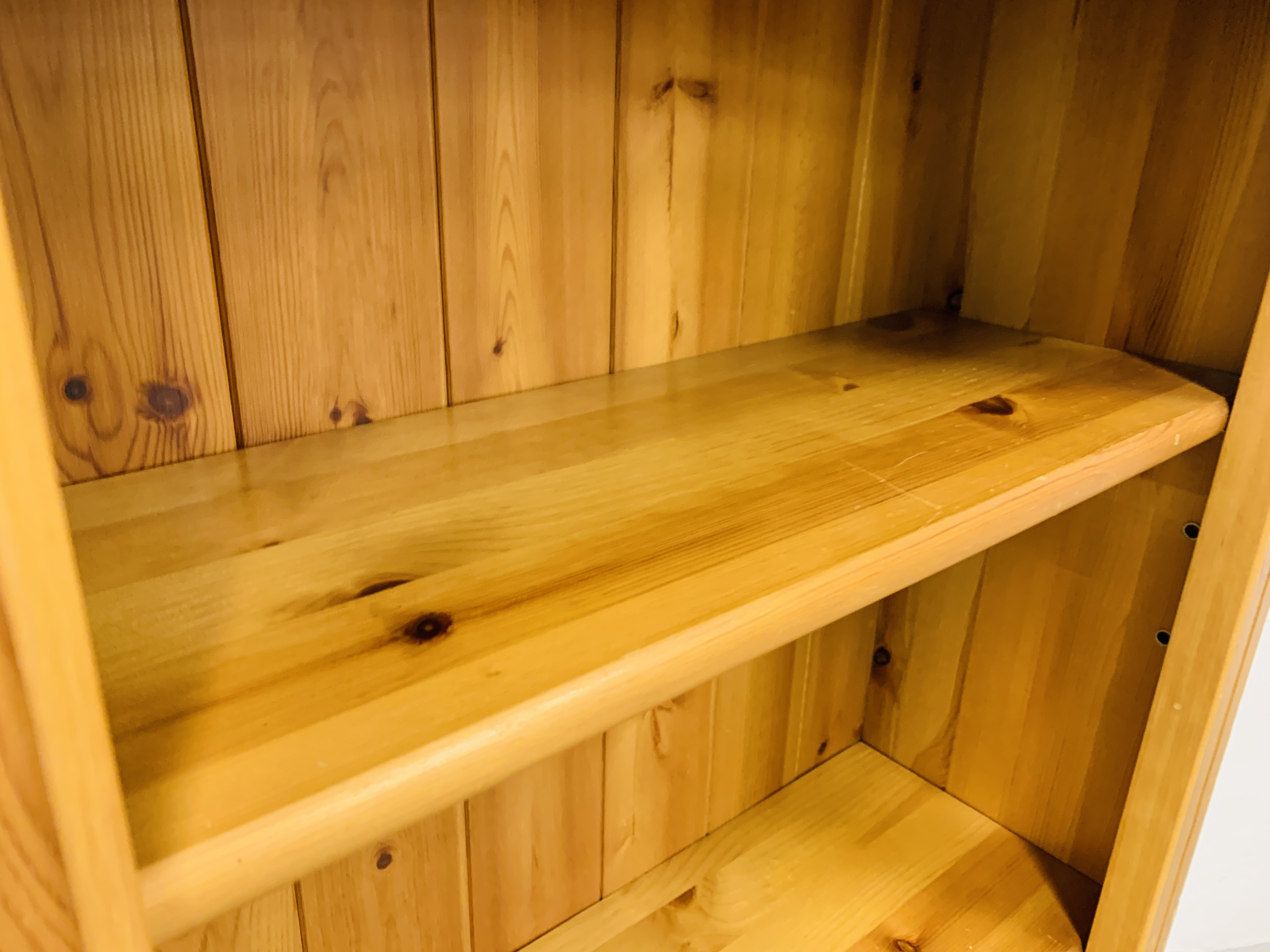 A SOLID HONEY PINE BOOKSHELF WITH TONGUE AND GROOVE BOARDED BACK - W 66CM. D 26CM. H 107CM. - Image 6 of 8