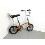 A RALEIGH BUDGIE 1969-1970 CHOPPER IN ORANGE FINISH AND CHROME MUD GUARDS AND HANDLE BARS