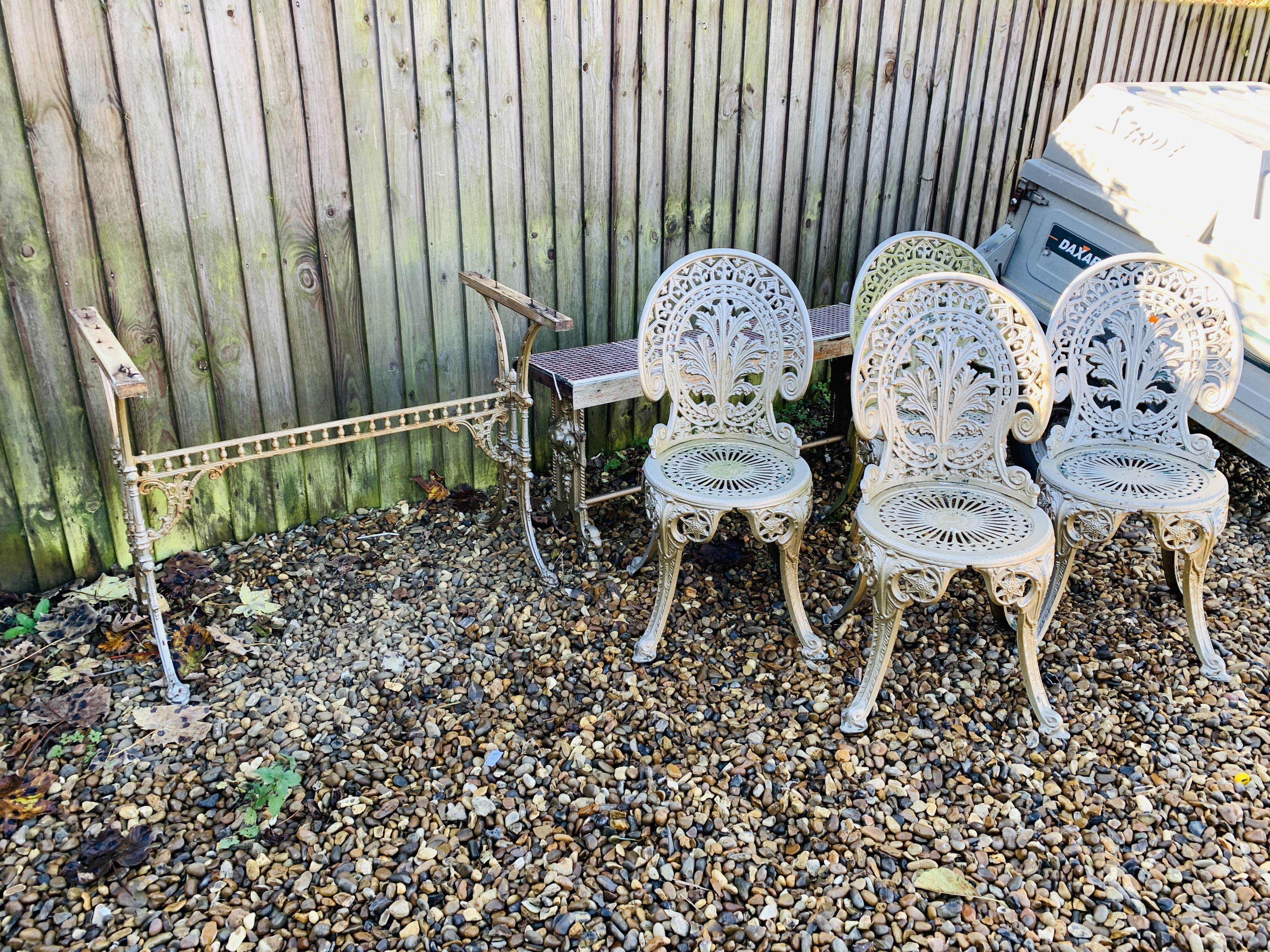 SET OF FOUR DECORATIVE CAST ALUMINIUM GARDEN CHAIRS ALONG WITH DECORATIVE CAST IRON TABLE BASE A/F