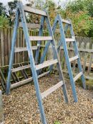 A PAIR OF VINTAGE WOODEN FOLDING DECORATORS TRESTLES - PLEASE NOTE NOT SUITABLE FOR USE,