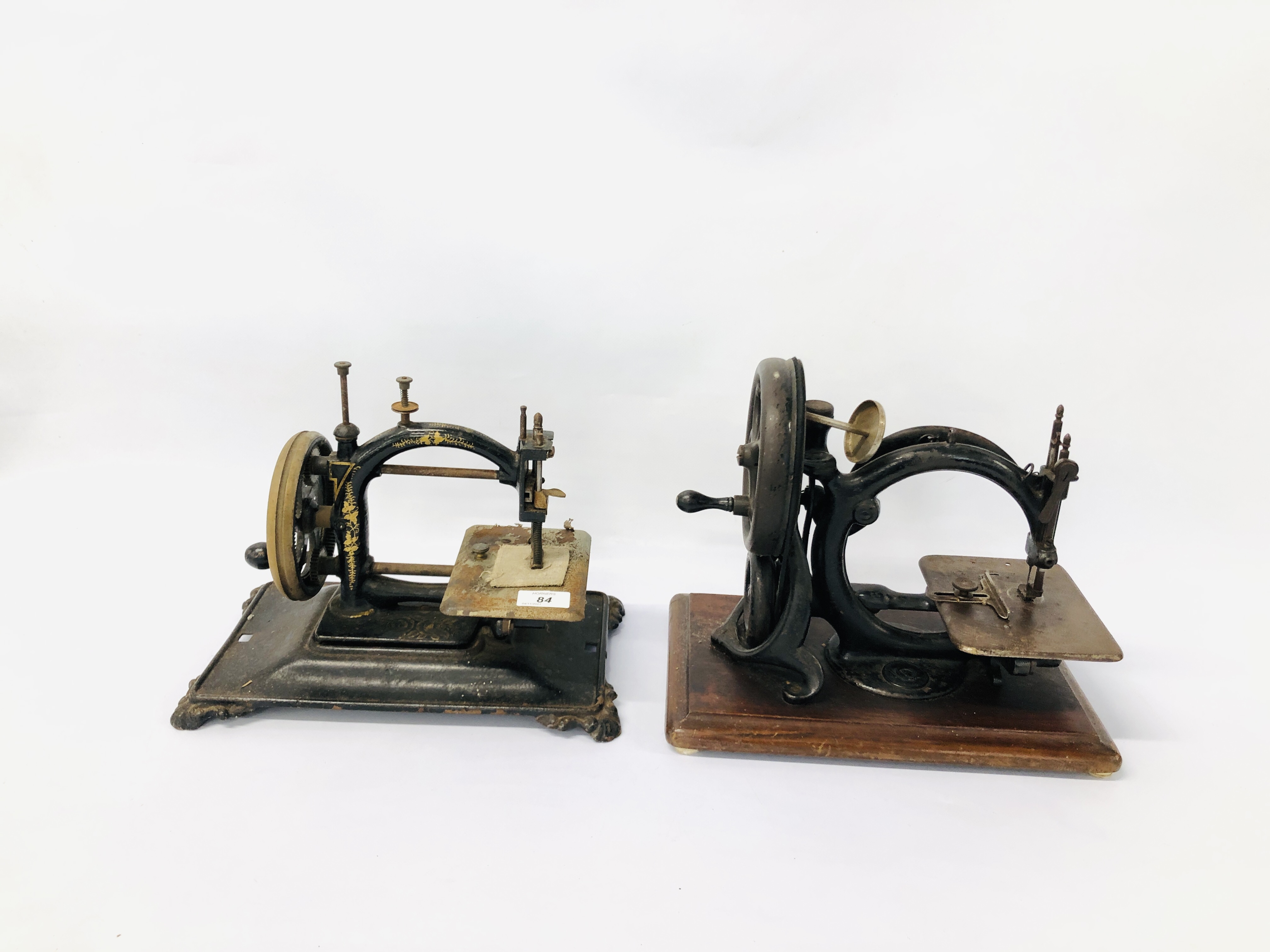 2 X VINTAGE SEWING MACHINES ONE HAVING A BLACK LACQUERED AND GILT FINISH