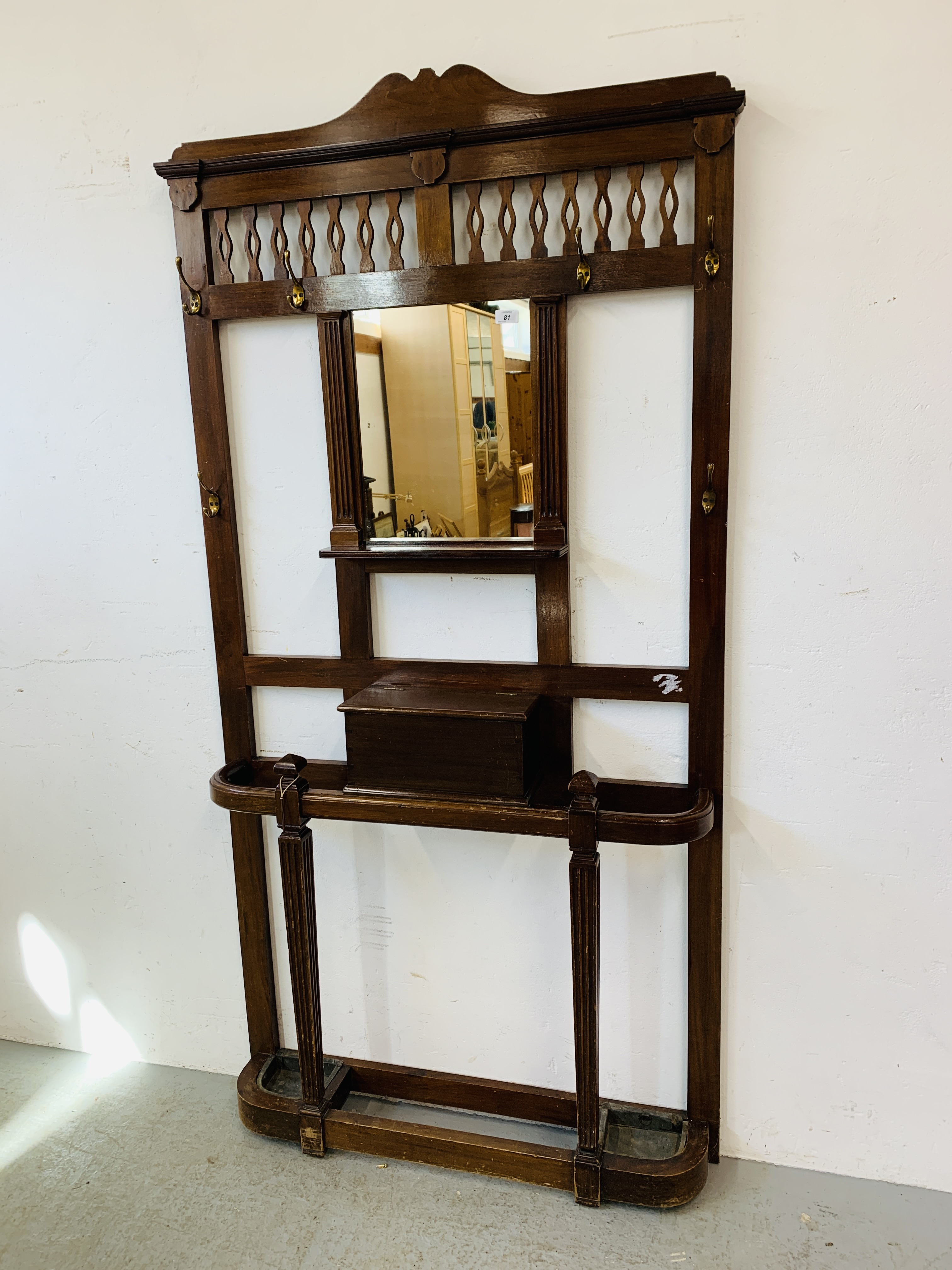A MAHOGANY HALL STAND WITH CENTRAL MIRROR AND GLOVE BOX. W 99CM. D 19CM. H 195CM.