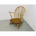 AN ERCOL BLONDE ROCKING CHAIR (BLUE LABEL)