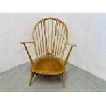 AN ERCOL BLONDE ARMCHAIR (BLUE LABEL)