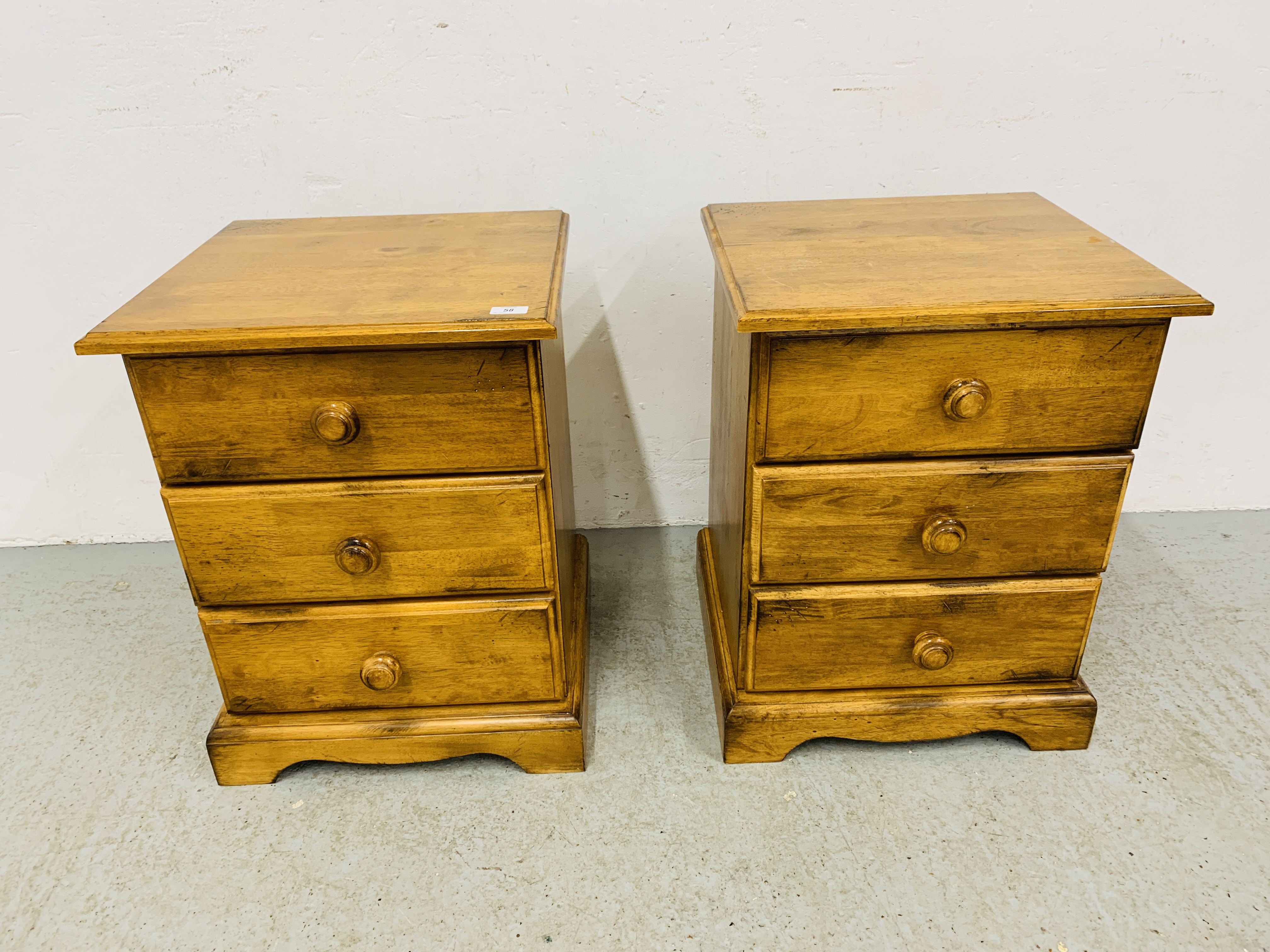PAIR OF MODERN HARDWOOD 3 DRAWER BEDSIDE CHESTS, WITH TURNED HANDLES - W 49CM. D 46CM. H 63CM.